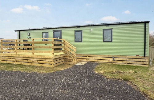 Castle Douglas House | 12ft-wide caravan situated in a coastal position.