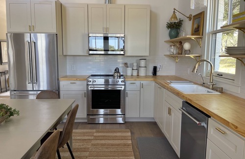 Johnson City House | 2 bedroom/2 bath stone farmhouse overlooking hill country creek on 50 acres