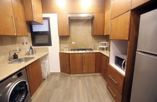 Sheikh Zayed City Apartment | A boho ground-floor apartment with garden view in a quiet area neighborhood