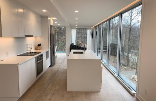 Lac Superieur Village Ski Chalet | Architectural home with panoramic mountain views.