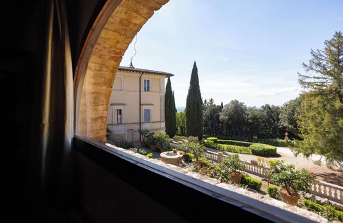 Siena House | Attic room with exposed beams, rustic Tuscan style