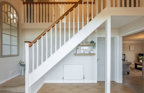 Docking House | Attractive chalet style brick and flint barn with a sunny, south facing garden