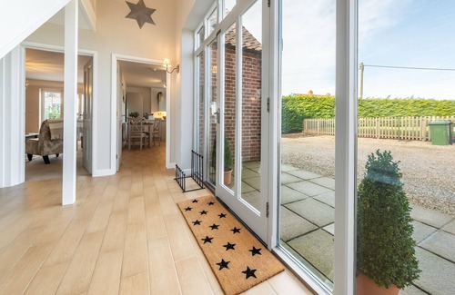 Docking House | Attractive chalet style brick and flint barn with a sunny, south facing garden