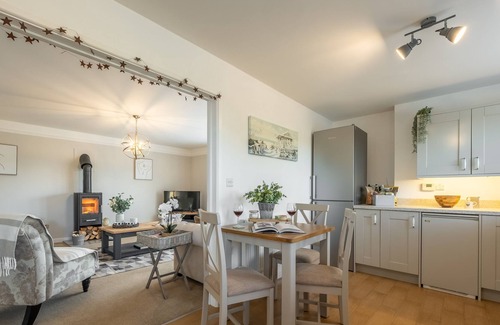 Docking House | Attractive chalet style brick and flint barn with a sunny, south facing garden