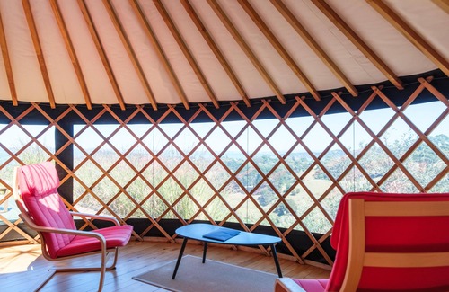 Palm Beach Cabin | Awaawa Yurts - Rangi Yurt - Awaawa Yurts offer a luxury glamping experience on Waiheke Island. Stunning views, luxury queen sized bed, private bathroom with tea and coffee making facilities.