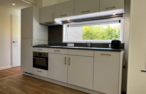 Sint Maartensvlotbrug House | Beautiful, brand new and uniquely designed chalet with pretty garden. Very spacious, modernly furnished for 5 people with luxurious "infinity" gas fireplace, wash-and-dryer and free WiFi.