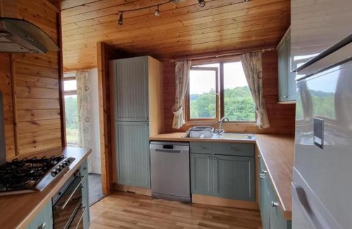 Grampound House | Beautiful Willow Lodge 67-4-6 persons-Private Hot Tub-Pet Friendly-Tranquil holiday away from it all yet not far to St Austell-The Holiday Home has two bedrooms, living & dining area, equipped kitchen -Decking-Al Fresco dining-Fishing lakes-Pet friendly