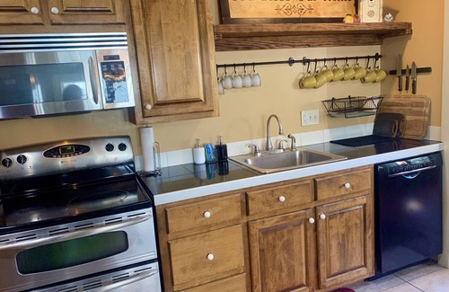 Lafayette House | Birdhouse Guesthouse & Gardens. Elegant home with outdoor seating & trees