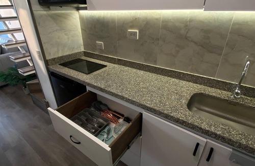 Barrios Unidos Apartment | Blessing House: Modern retreat with balcony, close to everything in Bogota.