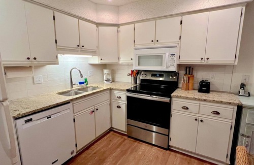 Port St. Joe House | Bright end unit across from pool -steps to beach ramp -beach chairs & cart incl.