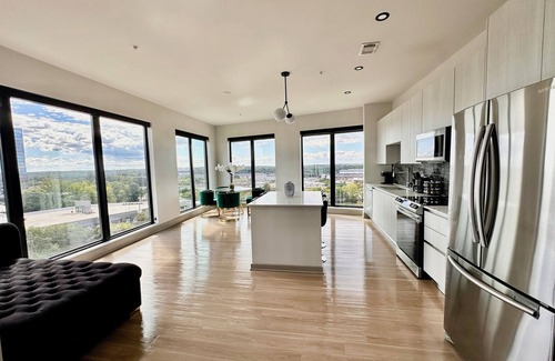 Westside Apartment | Ceiling to floor windows featuring a private balcony with stunning city views! n