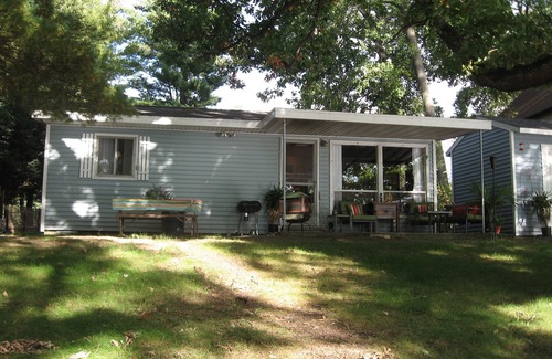 Evart Cottage | Charming Lakefront Cottage, Private Sandy Beach, Excellent Fishing
