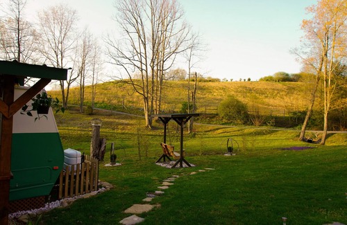 Canvas House | Cotch under a sugar maple tree w/firepit, swing and outdoor shower