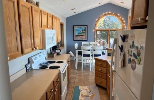 Lake Township House | Crystal Lake frontage, fire pit, kayaks, paddle boards, beach hut, AC, Dog ok