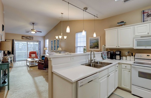 Sunset Beach Condo | Dog-friendly condo with balcony, pool access, & W/D - near beach and golf