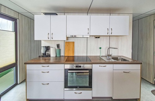 Lelystad Boat Rental | Enjoy a vacation on the water in this inviting houseboat in Lelystad.