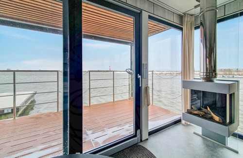 Lelystad Boat Rental | Enjoy a vacation on the water in this inviting houseboat in Lelystad.