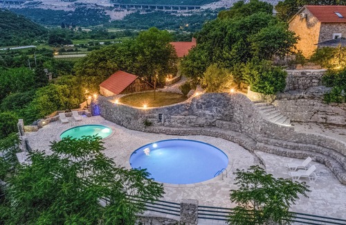Vrgorac House | Enjoy a wonderful view of the countryside from this inviting vacation home with pool access.