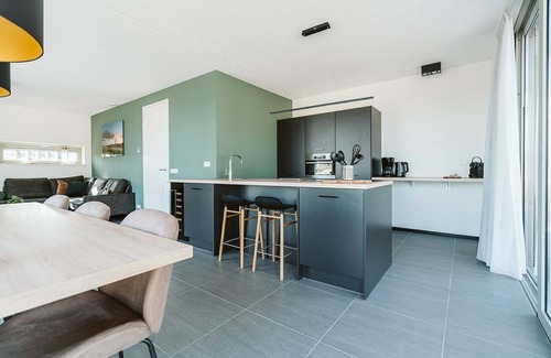 Ouddorp Resort | Enjoy all the extras of this vacation home, such as the wood-burning fireplace, wine refrigerator, and sun shower