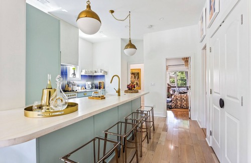 Midtown Apartment | Enjoy colorful vibes, velvet furniture, and a showstopper kitchen with funky blue hand-dyed tiles.