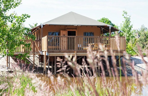 Nieuw Heeten House | Enjoy the ultimate glamping experience in the Safaricottage XL for 8 people by the pond at Vakantiepark de Sallandshoeve, perfect for families and nature lovers.