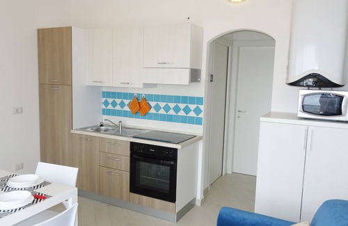 Paduledda Apartment | Equipped one-bedroom apartment with charming sea view, shared pool and washing machine