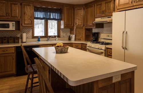 Eagle River House | Escape to the Northwoods at this picturesque Sand Lake home