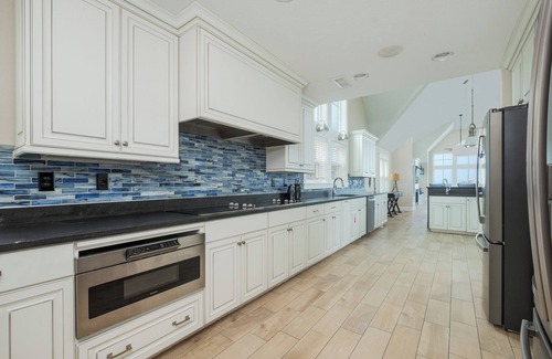 Kill Devil Hills House | Experience luxury at Seas the Day, a stunning 15-bedroom oceanfront retreat in Kill Devil Hills