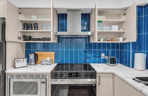 Calgary Apartment | Family-Sized Luxury Suite: King Bed, Workspace, Huge Lawn & Epic Sunset