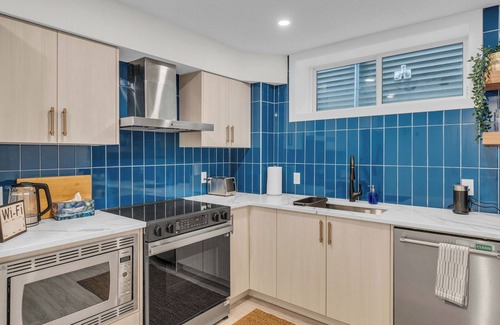 Calgary Apartment | Family-Sized Luxury Suite: King Bed, Workspace, Huge Lawn & Epic Sunset