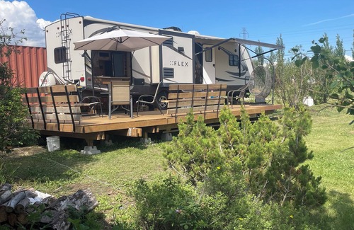 Leduc County House | Flex RV Travel trailer parked on a beautiful 4 acre lot, overseeing forest land.