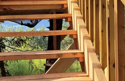 Armstrong House | Glamping in the woods with this Treehouse built in between 2 big alive Fir Tree