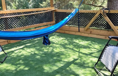 Armstrong House | Glamping in the woods with this Treehouse built in between 2 big alive Fir Tree