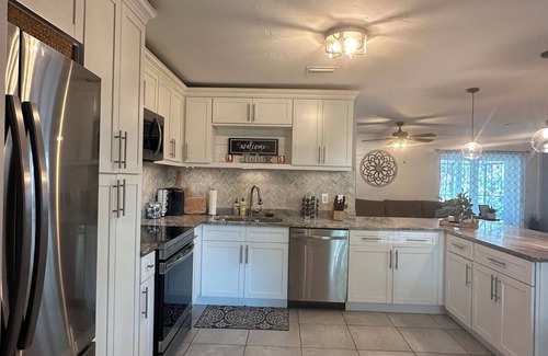 Pelican House | Gulf access pet friendly waterfront oasis with NEW heated salt water pool & spa