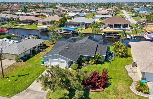 Pelican House | Gulf access pet friendly waterfront oasis with NEW heated salt water pool & spa