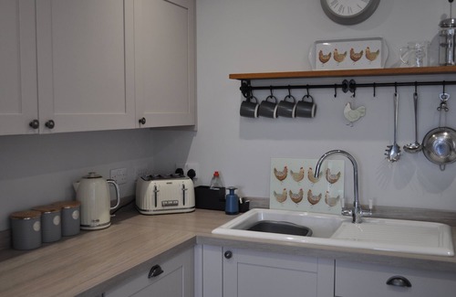 Mabe Cottage | Hot tub and covered seating area with log burner and BBQ