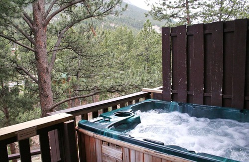 Estes Park Condo | Hot tub suite with full kitchen, patio with river view