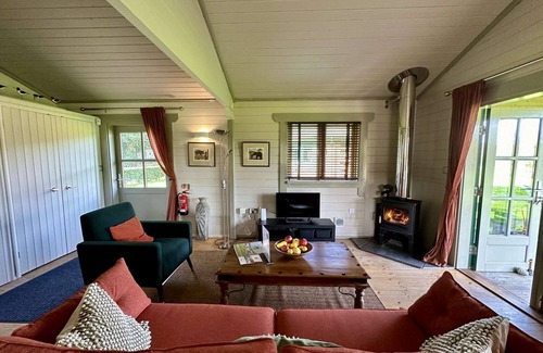 Ampney Crucis House | Iris Lodge with wood burner on Lake Pochard
