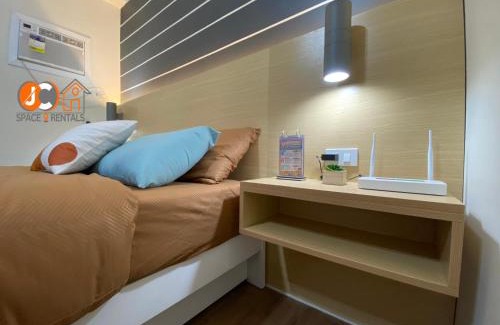 Mactan Export Processing Zone Apartment | JC SpaceRentals 127B Amani Grand Resort Residences, balcony pool view, Ground floor, 5 mins frm airport, free wifi, Netflix