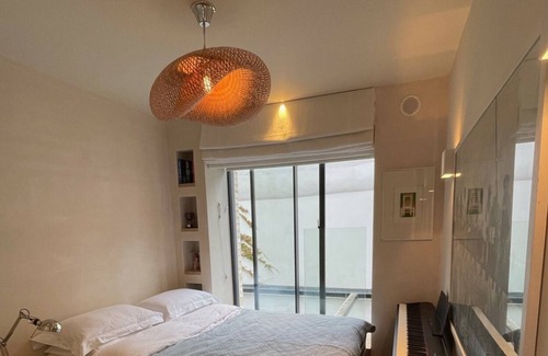 Addison Apartment | JOIVY Architectural gem w/ pool & terrace in West London