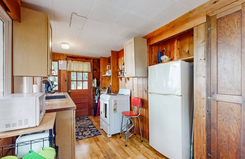 Laconia House | Lakefront cabin with deck, gas grill, kayaks, fireplace, & quick beach access