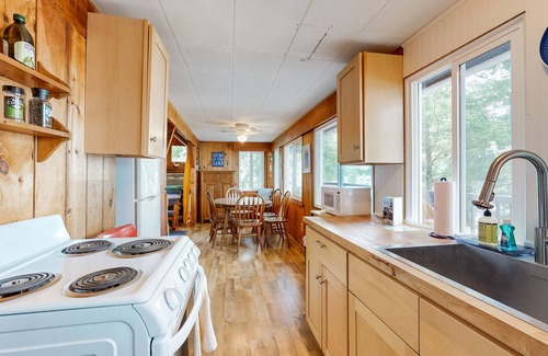 Laconia House | Lakefront cabin with deck, gas grill, kayaks, fireplace, & quick beach access