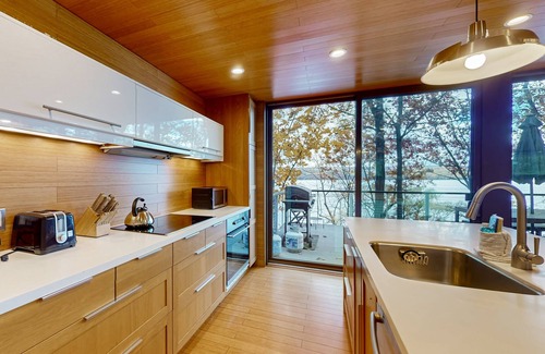 Valois House | Lakefront contemporary gem with decks, lake views & pebble beach