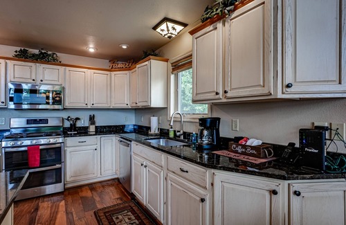 Eagle River House | Lakefront home with private dock, beach, firepit, playground, deck & game room