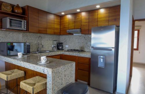 South Hotel Zone Hotel | Los Tules 501 one bedroom apartment with ocean views and lush palm gardens