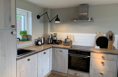 Fehmarn House | Lovingly furnished beach house, directly on the beach with fireplace and large garden