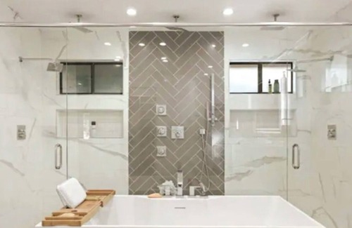 Modesto House | Lux Home wall-to-wall shower with nine heads ensuring a luxurious experience.