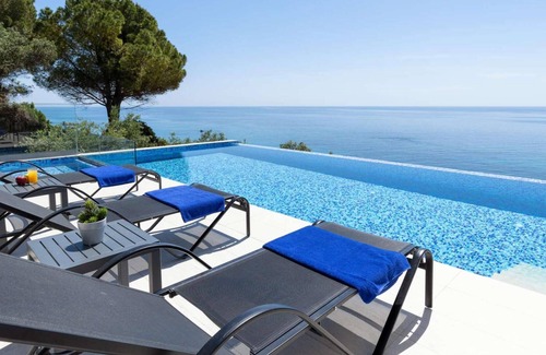 Agios Matthaios Villa | Luxury villa, coastal setting, sea views.
