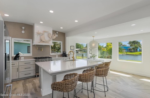 Cocoa Beach House | Luxury Waterfront -Heated Pool, Dock, Bikes & Paddleboards - Mins to Beach