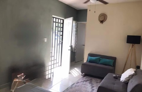 Cancun House | MiniHouse in front of park with parking.